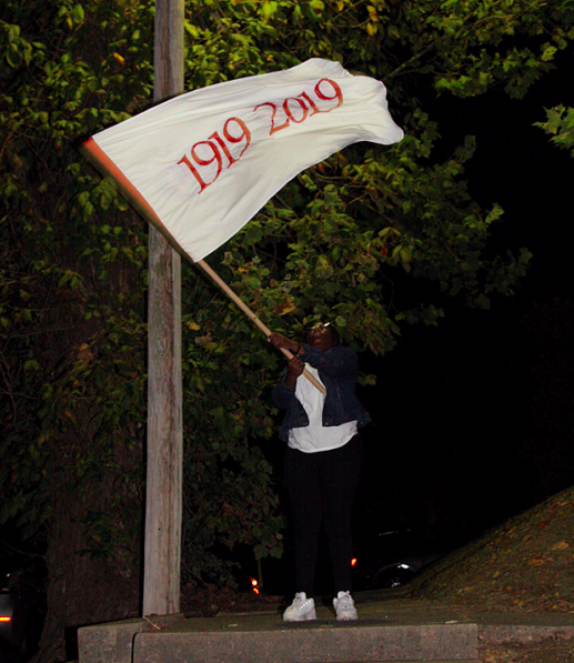 HELENA-WEST HELENA. Kai Mitchell waves one of the Remember 2019 flags in the night to welcome listening party participants